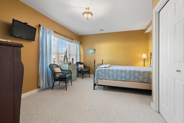 bedroom with light carpet and a closet