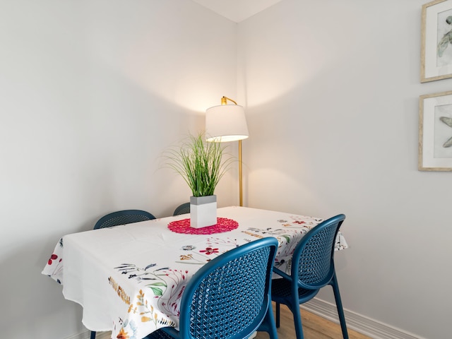 dining space with wood-type flooring