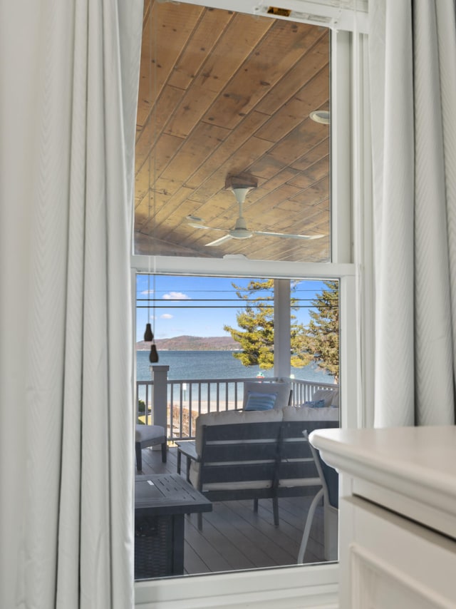 interior space featuring ceiling fan and a water view