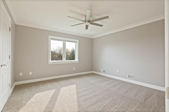 carpeted empty room featuring ceiling fan and ornamental molding