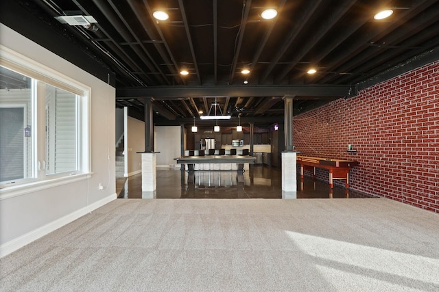 basement with dark carpet and brick wall