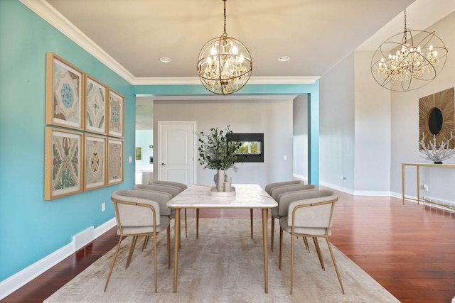 dining room with crown molding, dark wood-type flooring, and a notable chandelier