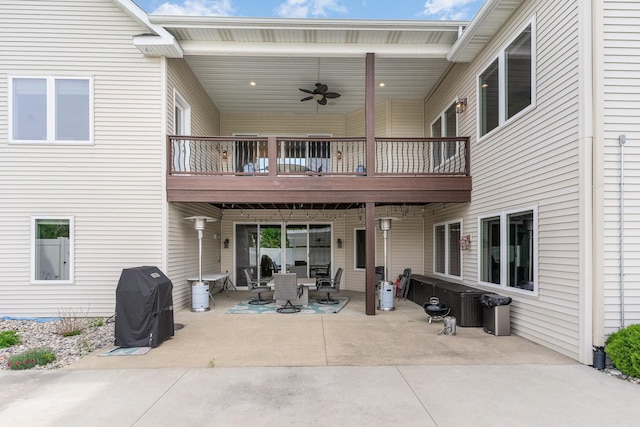 rear view of house with ceiling fan, a patio, and a wooden deck