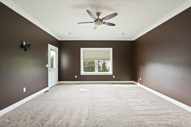 unfurnished room featuring light colored carpet, ceiling fan, and ornamental molding