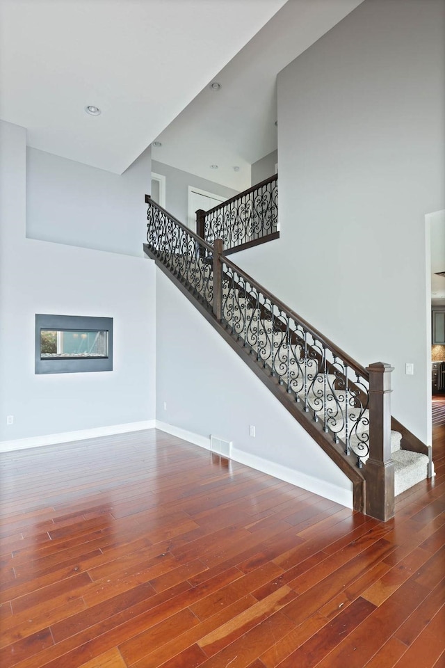 staircase with wood-type flooring