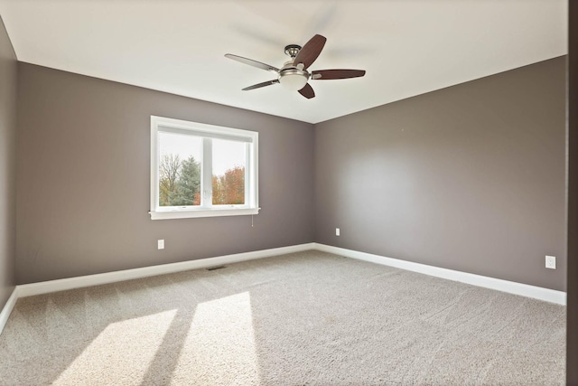 empty room with ceiling fan and carpet