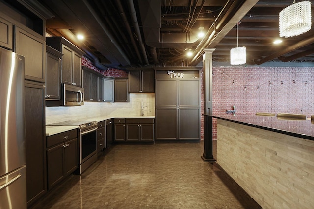 interior space featuring stainless steel refrigerator, sink, and a chandelier