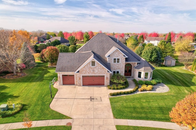 view of front of home with a front yard and a garage