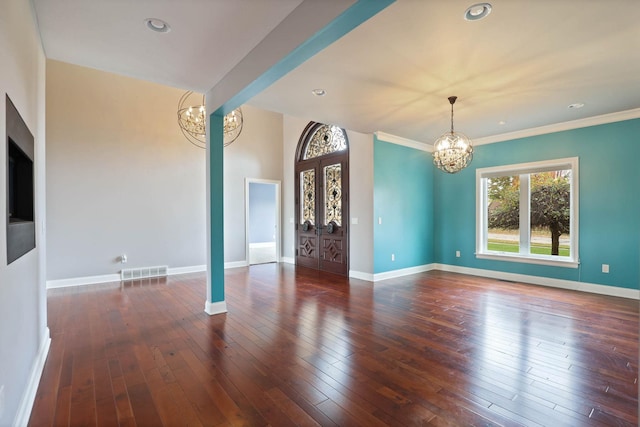 interior space with ornamental molding, dark wood-type flooring, and a chandelier