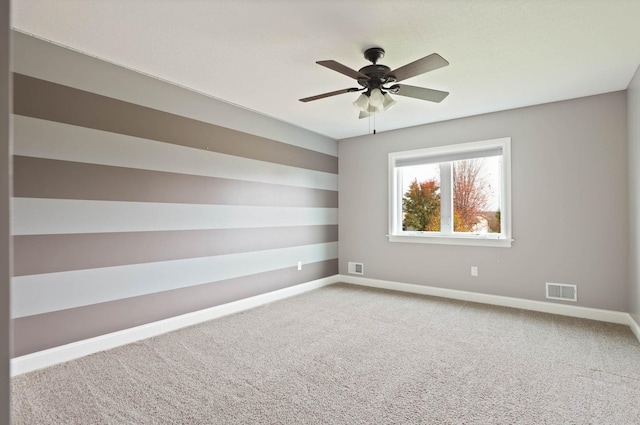 carpeted empty room featuring ceiling fan