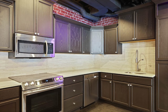 kitchen with dark brown cabinets, backsplash, stainless steel appliances, and sink