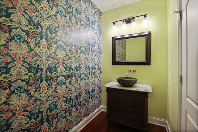 bathroom with hardwood / wood-style floors and vanity