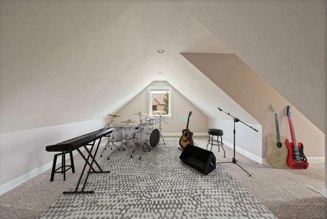 recreation room featuring carpet flooring, a textured ceiling, and vaulted ceiling