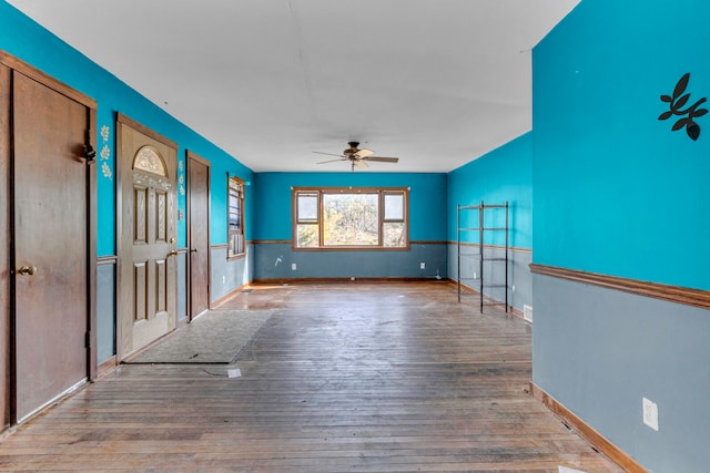 unfurnished living room with ceiling fan and hardwood / wood-style flooring