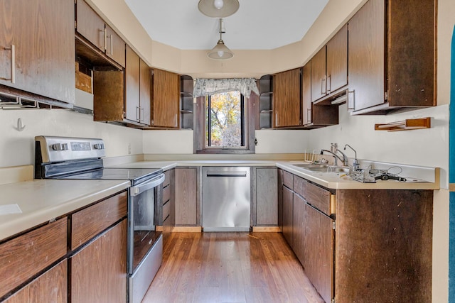 kitchen featuring sink, wood-type flooring, and appliances with stainless steel finishes