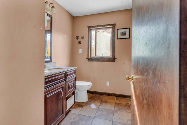 bathroom with tile patterned flooring, vanity, and toilet