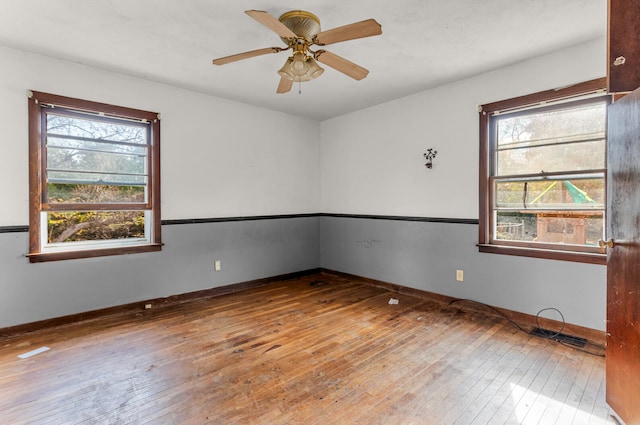 unfurnished room with ceiling fan and hardwood / wood-style floors