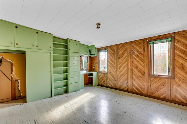 unfurnished bedroom featuring wood walls