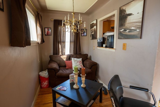 living room featuring hardwood / wood-style floors and an inviting chandelier