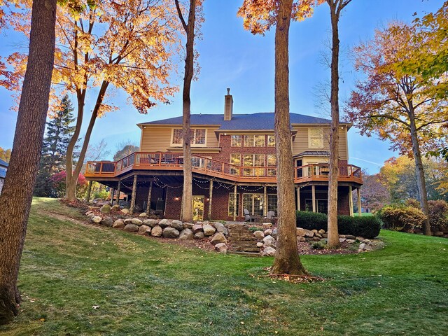 back of house featuring a yard and a wooden deck