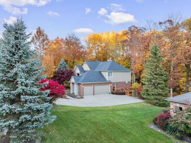 view of side of property with a yard and a garage