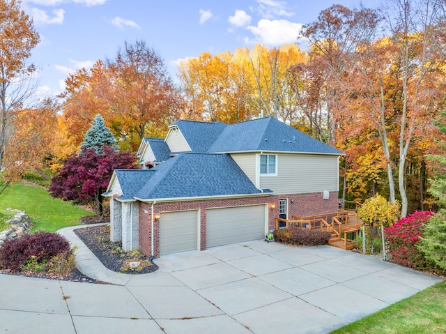 view of side of property with a garage and a wooden deck