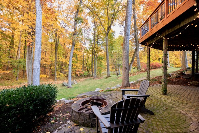 view of patio / terrace with a deck and an outdoor fire pit