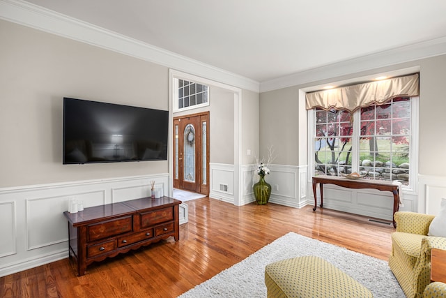 living room featuring crown molding and wood-type flooring