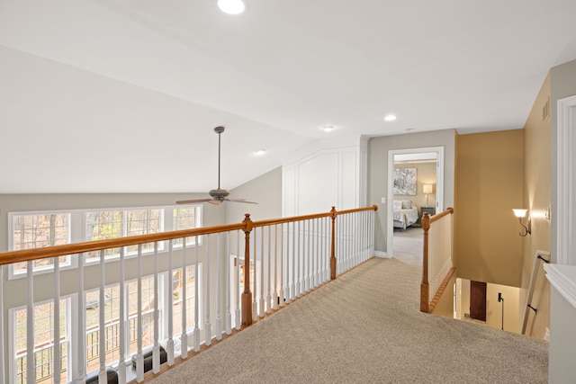 hall featuring light carpet and lofted ceiling