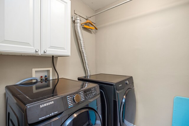 laundry room featuring cabinets and separate washer and dryer