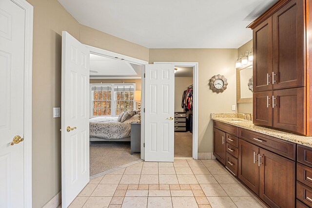 bathroom featuring tile patterned flooring and vanity