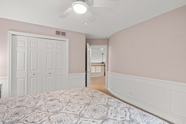 carpeted bedroom with a closet and ceiling fan