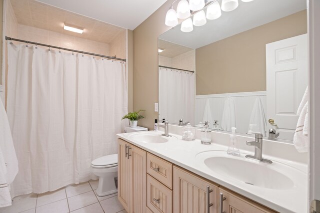 bathroom with tile patterned flooring, vanity, and toilet