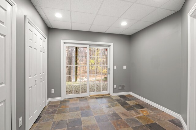 doorway to outside featuring a paneled ceiling