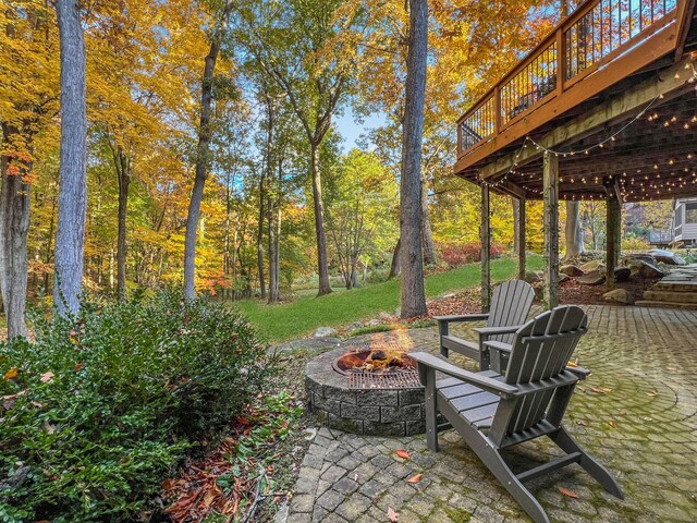 view of patio with a fire pit and a deck