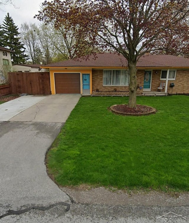 single story home featuring a front lawn and a garage