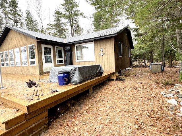 back of house with a deck