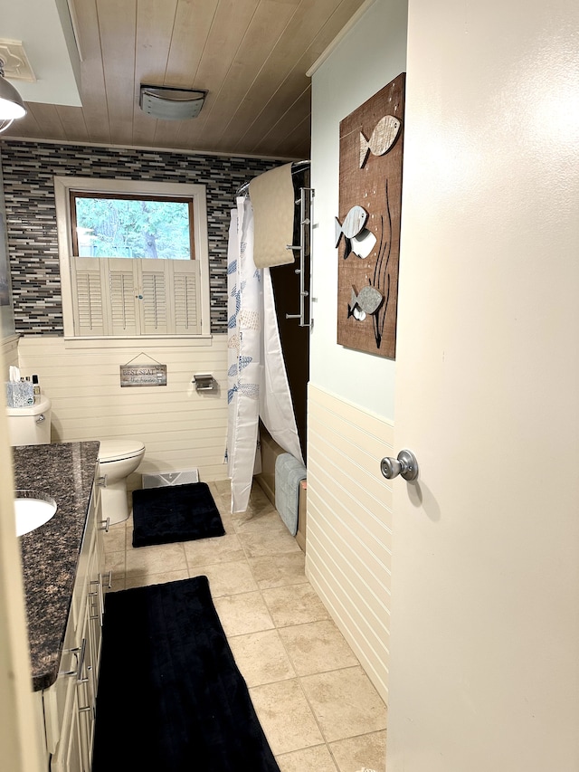 bathroom featuring wood ceiling, vanity, tile patterned flooring, toilet, and wood walls