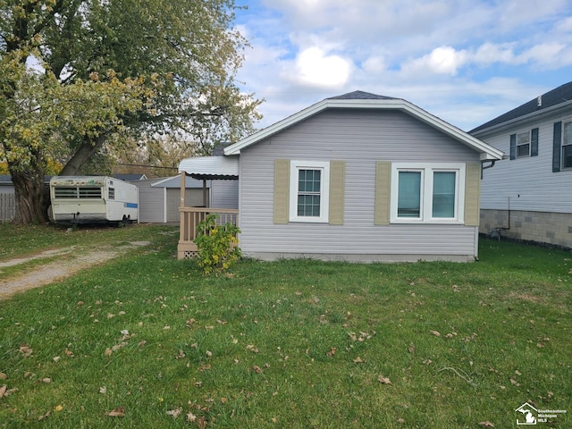 view of side of home with a yard