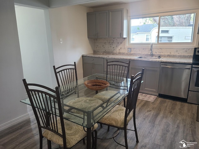 dining area with dark hardwood / wood-style floors and sink