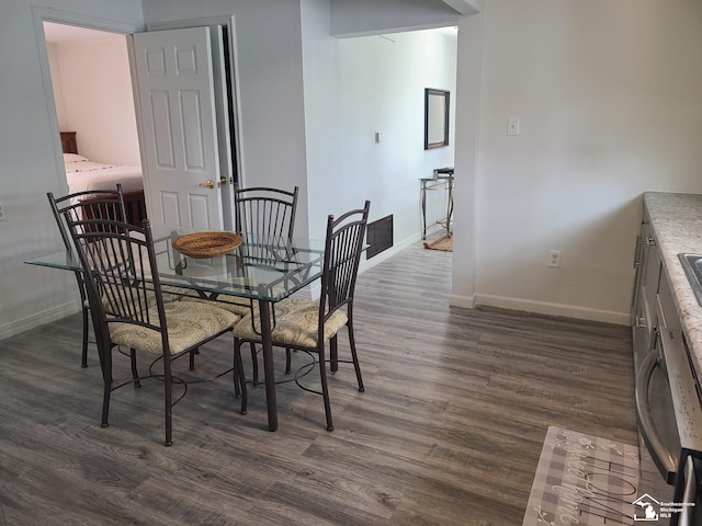 dining room with dark wood-type flooring