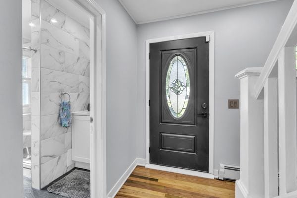 entrance foyer with hardwood / wood-style flooring and baseboard heating