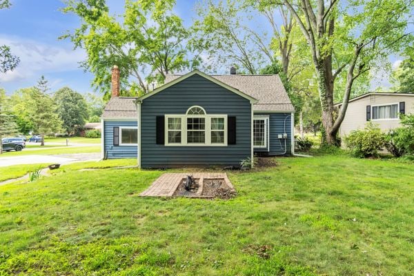 rear view of house with a lawn