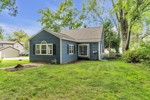 rear view of house featuring a yard