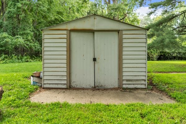 view of outbuilding featuring a lawn