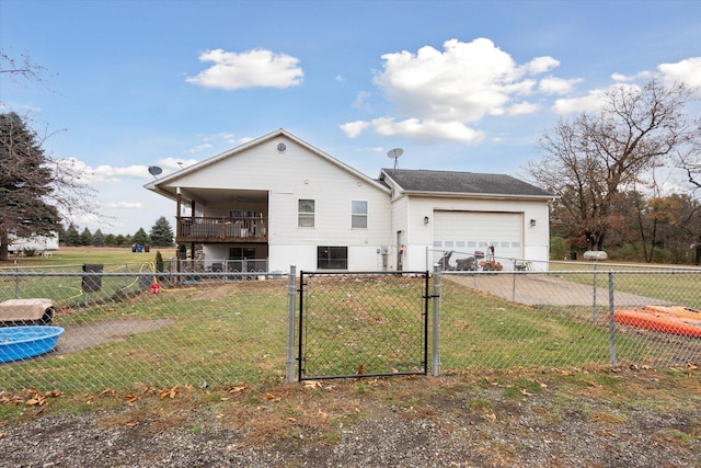 rear view of property featuring a yard and a garage