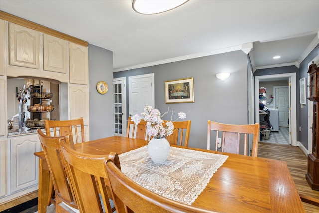 dining room featuring ornamental molding and light hardwood / wood-style flooring