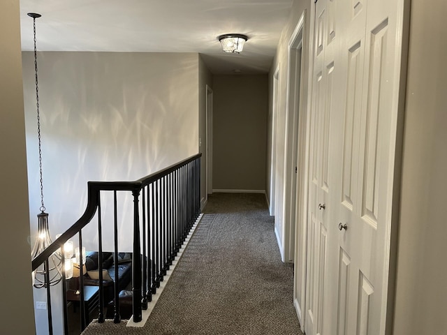 corridor with dark colored carpet