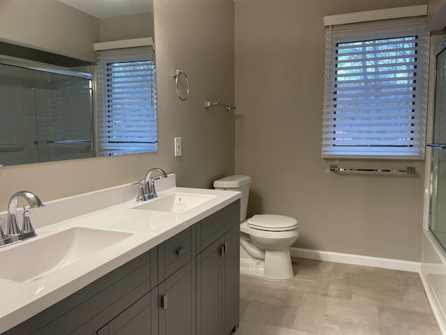 full bathroom with vanity, enclosed tub / shower combo, and toilet