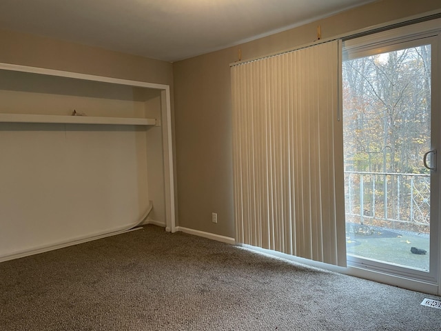 unfurnished bedroom with carpet and multiple windows